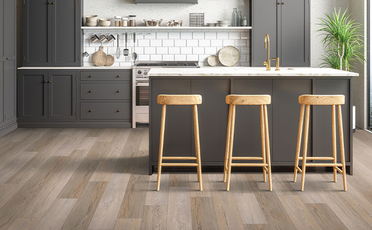 luxury vinyl plank flooring in kitchen with dark gray cabinetry.